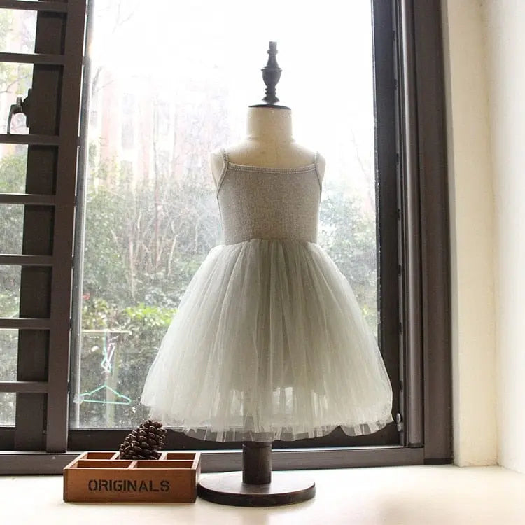 White tulle flower girl gown for kids, elegant fluffy dress perfect for weddings, birthdays, and special occasions by Showlu Fashion.