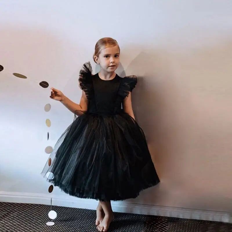 White tulle flower girl gown by Showlu Fashion Store, elegant fluffy dress for kids' weddings, birthdays, and special occasions.
