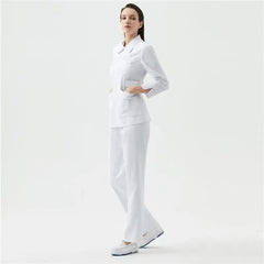 A woman models a white long-sleeve medical scrub uniform with a collared top and matching pants.