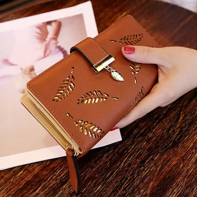 Showlu women's PU leather long wallet with gold hollow leaf design, featuring multiple card slots and a coin pocket.
