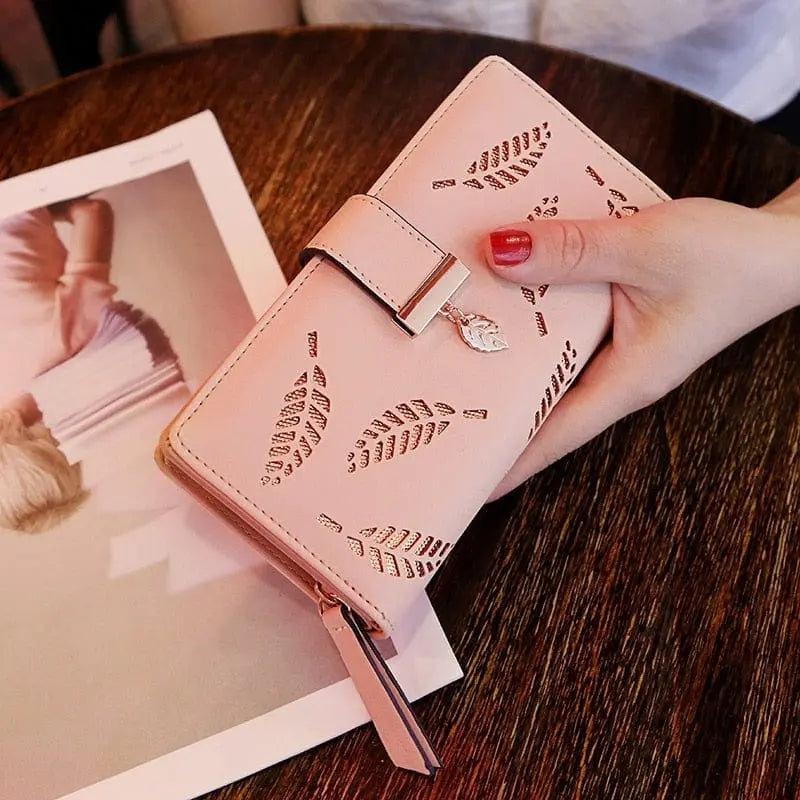 Showlu women's PU leather long wallet with gold hollow leaf design, featuring card slots, coin pocket, and clutch-style purse.