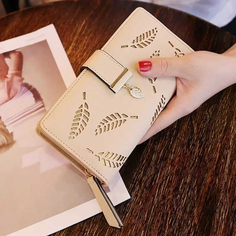 Showlu women's PU leather long wallet with gold hollow leaf design, featuring coin purse, card slots, and clutch style.