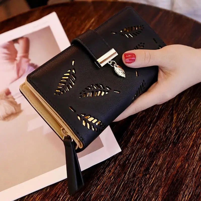 Showlu women's PU leather long wallet with gold hollow leaf design, featuring card slots, coin pocket, and clutch-style appearance.