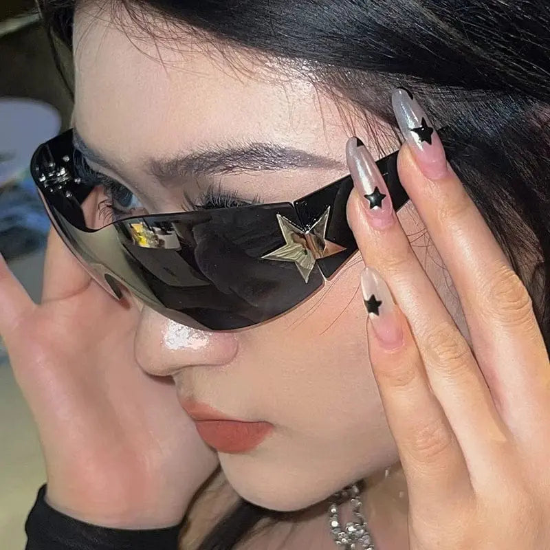 Orange frameless five-pointed star pilot sunglasses with trendy Y2K style, fashionable all-in-one design for women.
