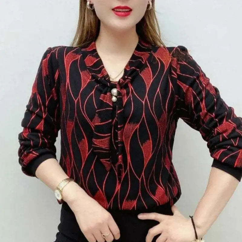 Wave printed V-neck blouse by Showlu Fashion with pearl and diamond embellishments, featuring a chic, three-dimensional design.