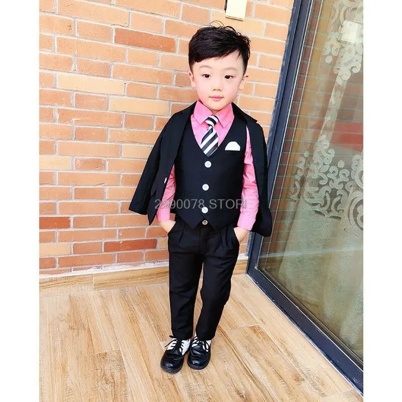 Boy's white wedding suit with blazer, bowtie, and formal trousers, perfect for special occasions and ceremonies.