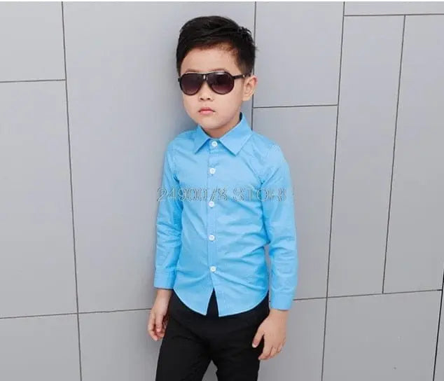 Boy wearing a white wedding suit with a bowtie, formal tuxedo style, for special occasions and ceremonies.