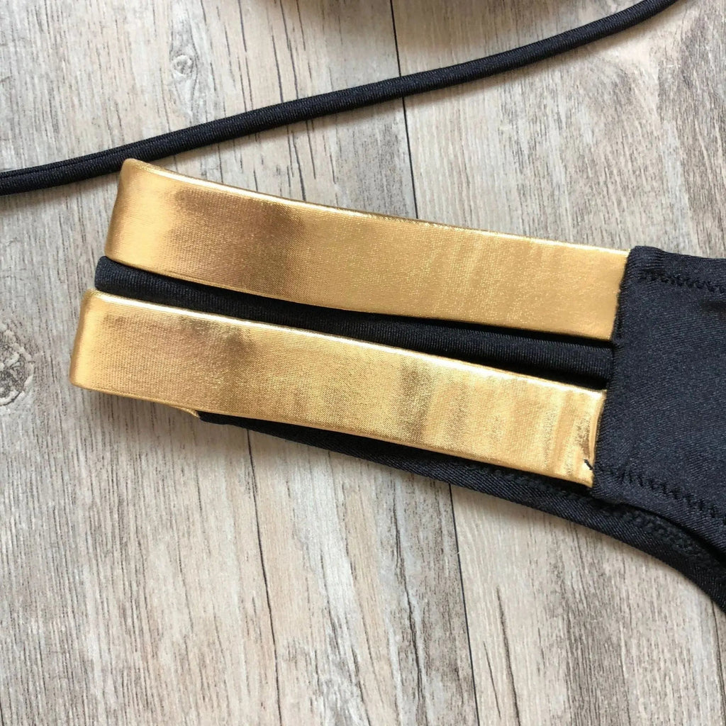 Gold stamping bikini set by Showlu Fashion, featuring padded Brazilian swimwear with stylish gold accents and a fitted design.
