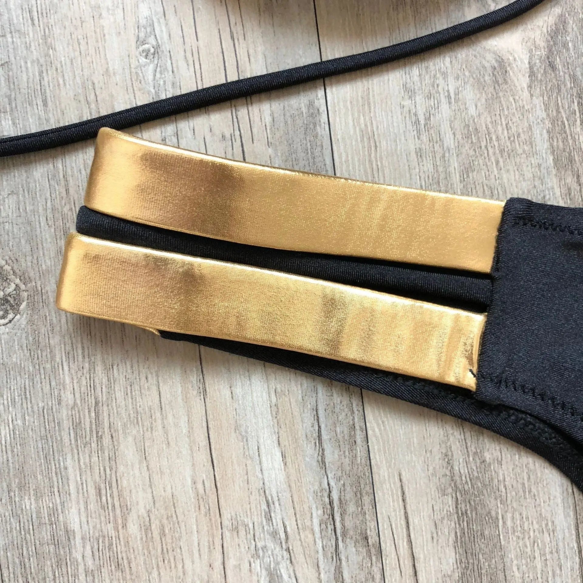 Gold stamping bikini set by Showlu Fashion, featuring padded Brazilian swimwear with stylish gold accents and a fitted design.
