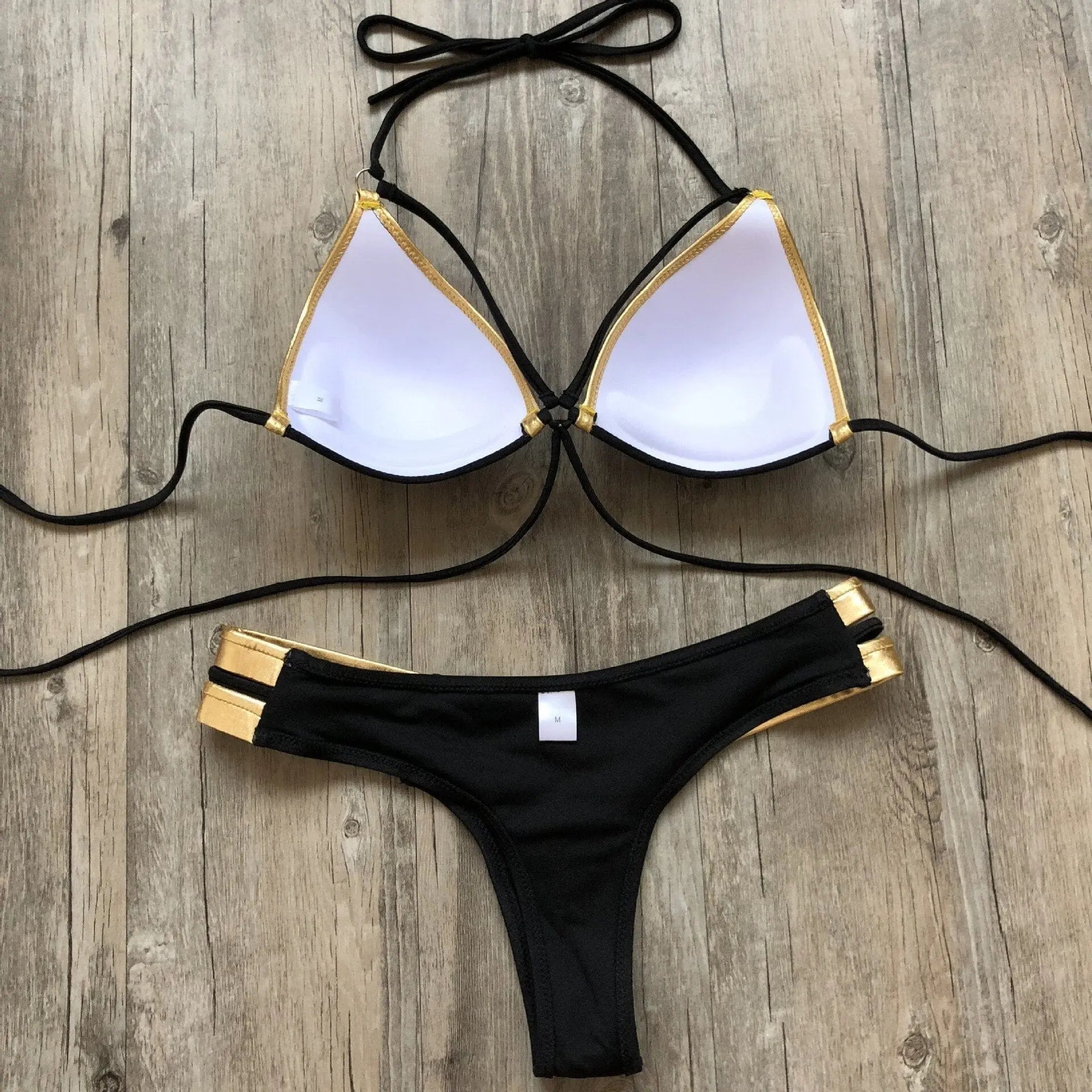 Gold stamping bikini set by Showlu Fashion, padded Brazilian swimwear featuring gold accents and a stylish, fitted design.