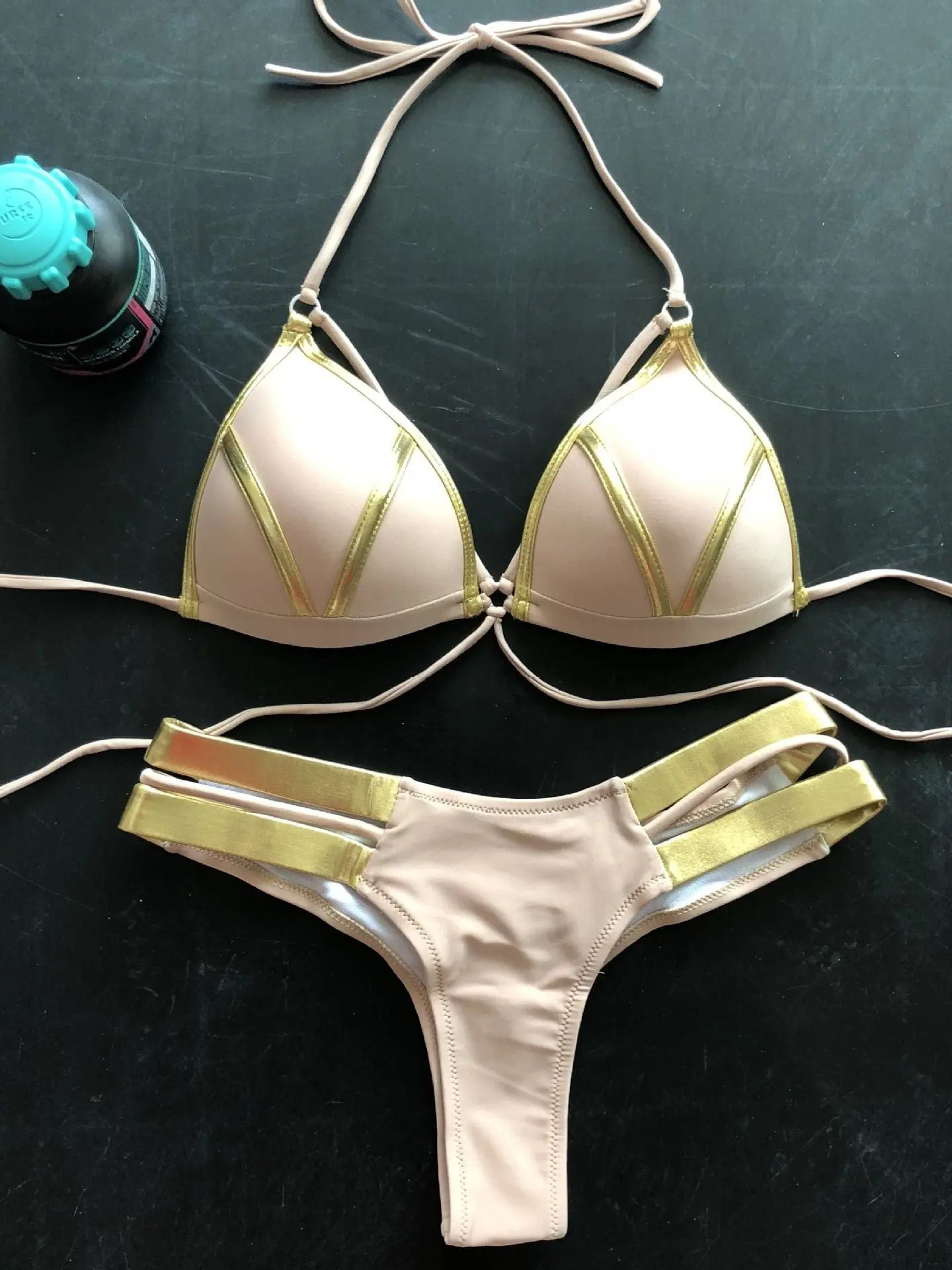 Gold stamping bikini set by Showlu Fashion, padded Brazilian swimwear with gold details, displayed on a neutral background.