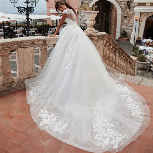 Lace Cinderella ball gown wedding dress with sweetheart neckline and full skirt, featuring intricate floral details by Showlu Fashion.