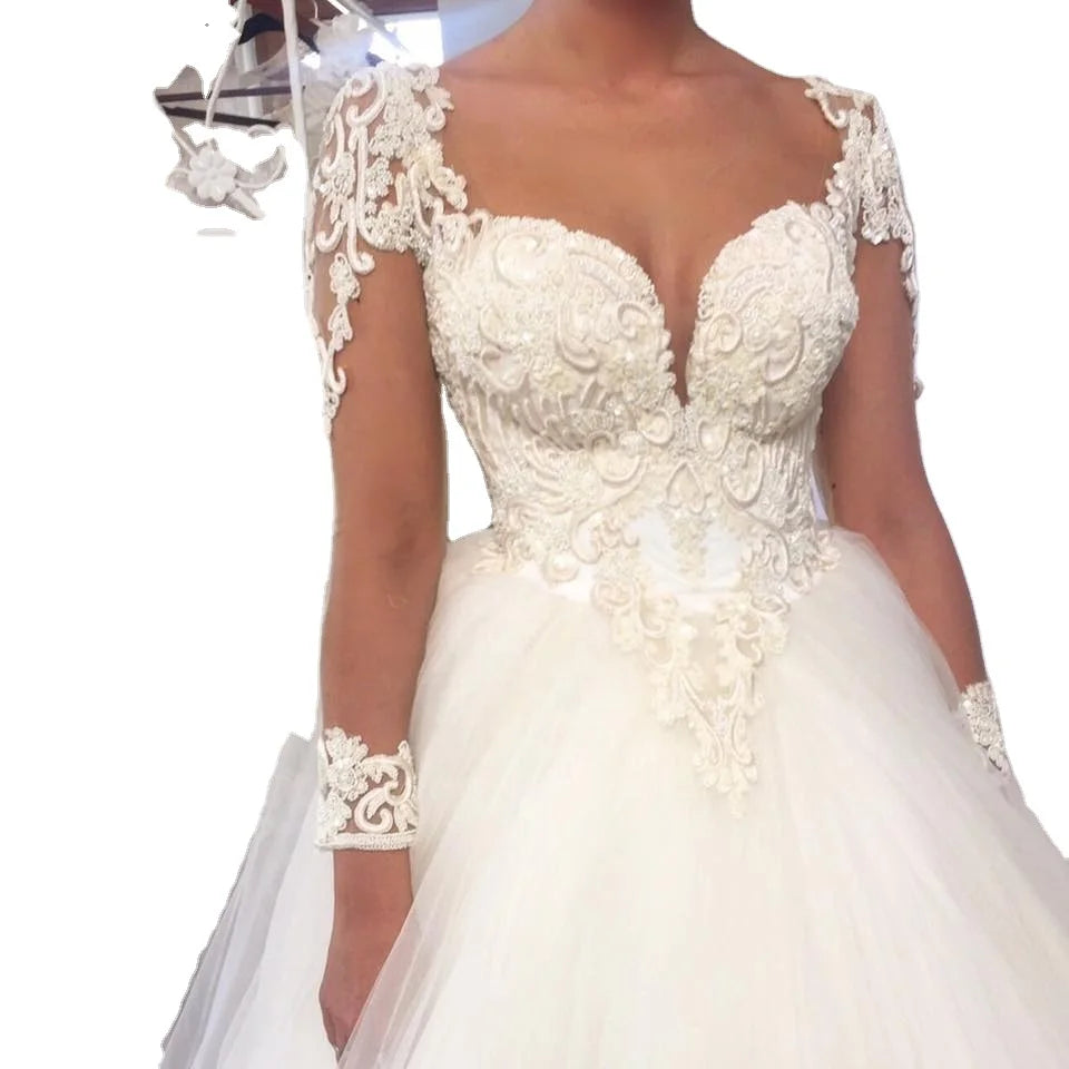 Elegant white Aster Garden long sleeve lace ball gown wedding dress with intricate lace details and a flowing skirt.