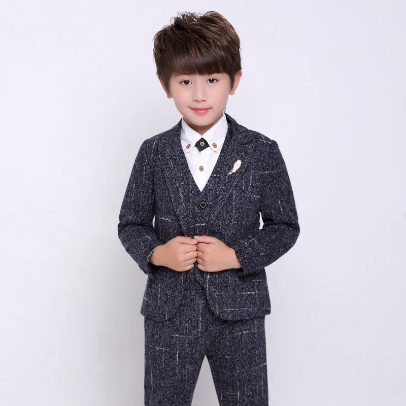 Boy wearing LUOBOBEIBEI formal plaid wedding suit with blazer and pants, stylish 4-piece set for special occasions.