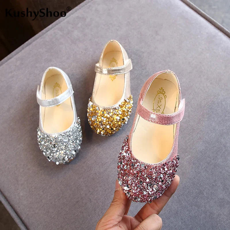 KushyShoo girls glitter princess toddler flat dance sandals with sparkly straps and bow detail, perfect for special occasions.