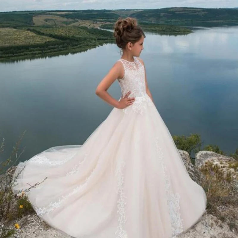 White flower girl dress by Showlu Fashion Store featuring lace applique and beaded details for first communion or special occasions.