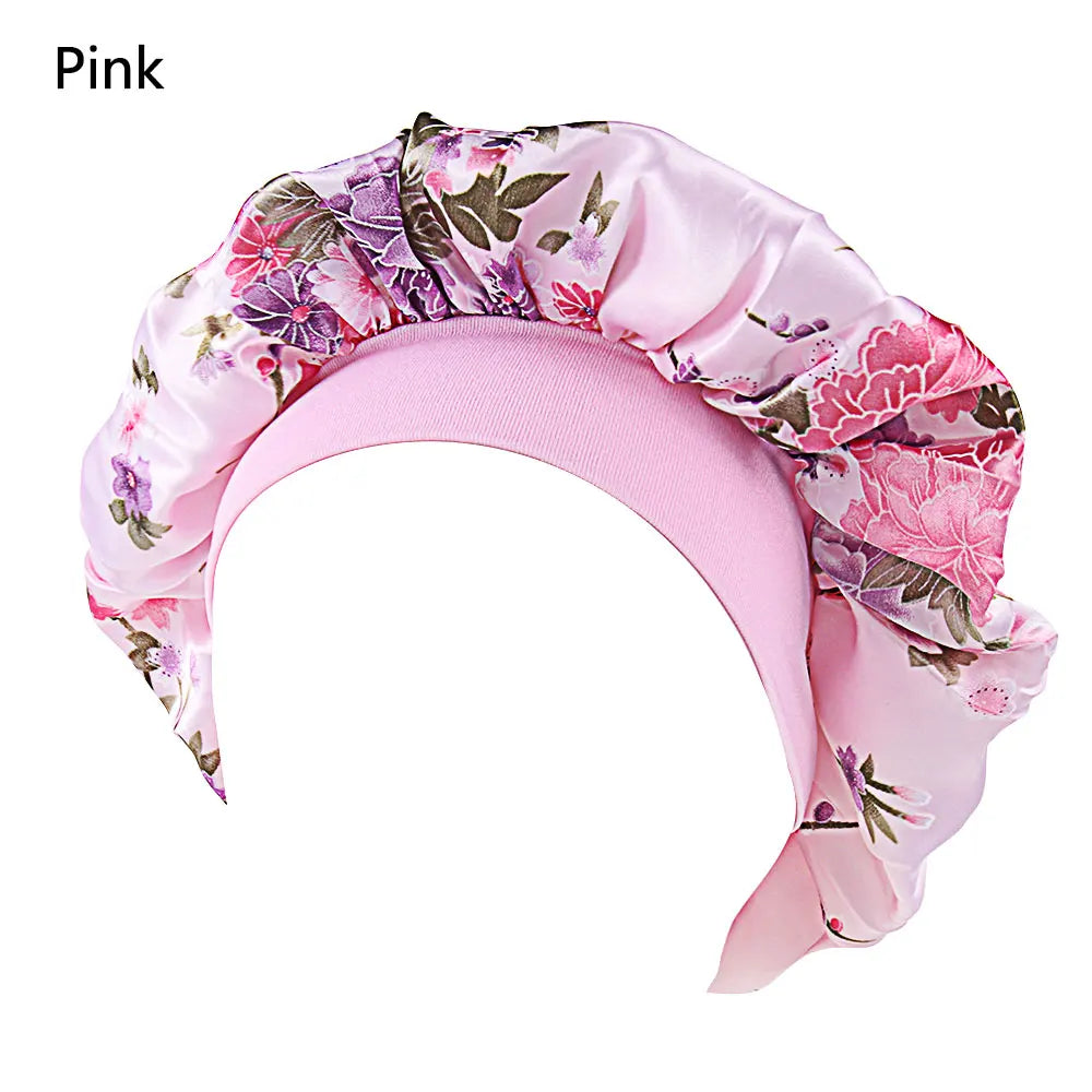 Black satin women's sleep bonnet with wide elastic band, ideal for hair protection, chemo caps, and night hair care.