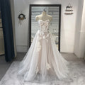 Strapless appliqued tulle wedding gown with lace A-line silhouette, sweetheart neckline, court train, perfect for bridal occasions.