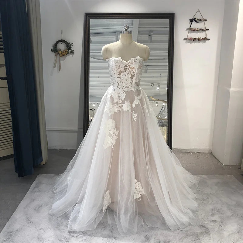 Strapless appliqued tulle wedding gown with lace A-line silhouette, sweetheart neckline, court train, perfect for bridal occasions.