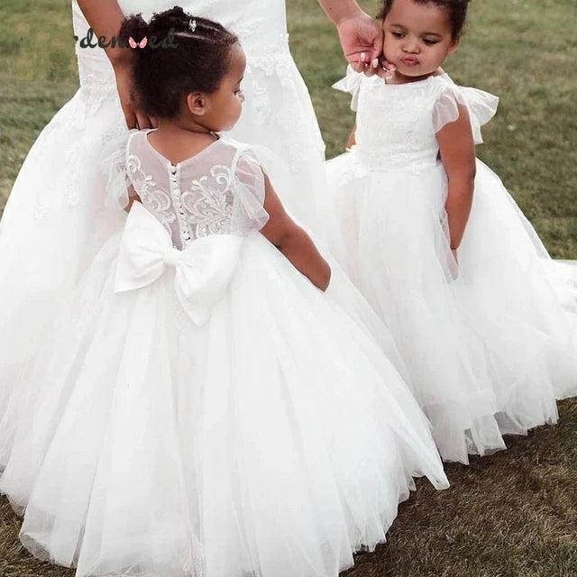 White lace flower girl dress with appliqué and puffy ball gown design by Showlu Fashion, perfect for special occasions.