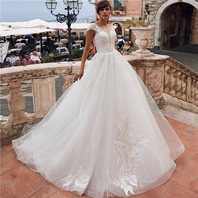 Lace Cinderella ball gown wedding dress with sweetheart neckline, full skirt, and intricate floral lace details by Showlu Fashion Store.