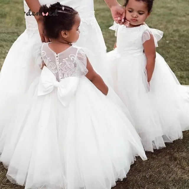 White lace flower girl dress with appliqué and puffy ball gown design by Showlu Fashion, perfect for special occasions.