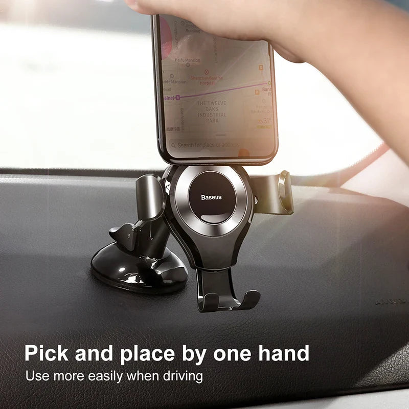 Baseus Gravity Car Phone Holder with suction cup dashboard mount in black, designed to securely hold smartphones during driving.
