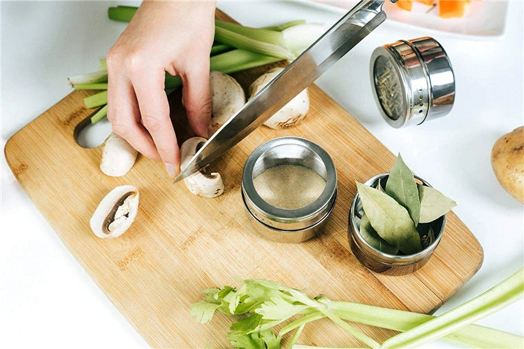Magnetic stainless steel spice jar set by Showlu Smart General with clear lids, mounted on a kitchen wall for organized spice storage