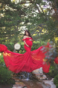 Pregnant woman in off-shoulder cotton and chiffon maternity gown, ideal for maternity photography and pregnancy photo shoots.