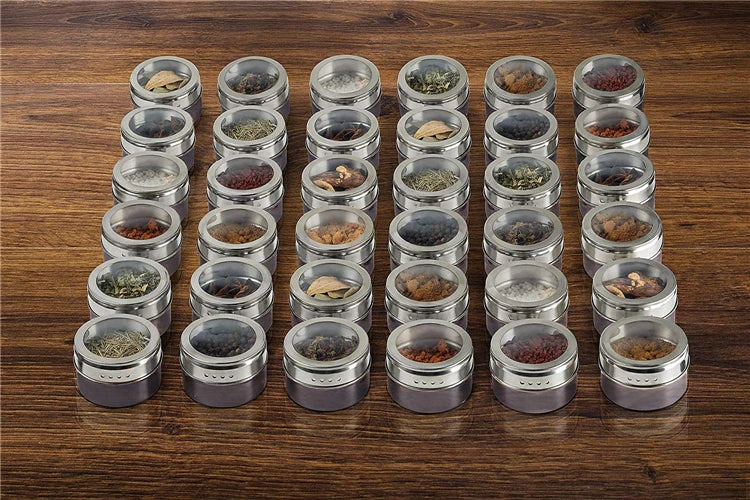 Magnetic stainless steel spice jar set with labeled lids for organized kitchen storage, shown in a close-up view.