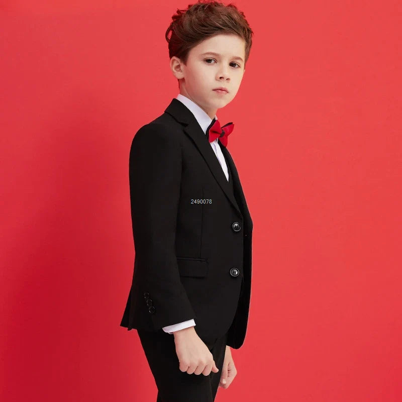 Kids black wedding suit set by SHOWLU FASHION STORE, includes formal blazer, vest, shirt, pants, and tie for boys' special occasions.