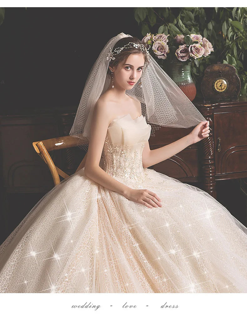 Aster Garden lace wedding dress by Showlu Fashion, off-shoulder high-low bridal gown with intricate lace details and flowing train.