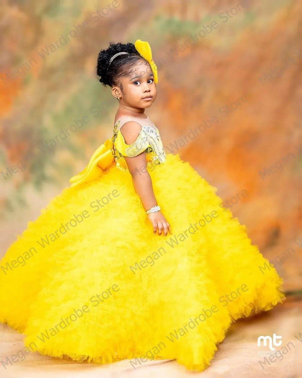 Yellow tiered tulle flower girl dress with big bow, ball gown style by Showlu Fashion Store, perfect for special occasions.