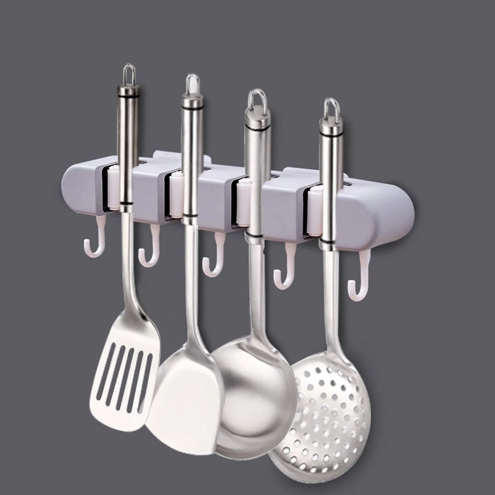 Wall mounted broom holder by Showlu Smart General, featuring multiple slots to organize brooms and cleaning tools.