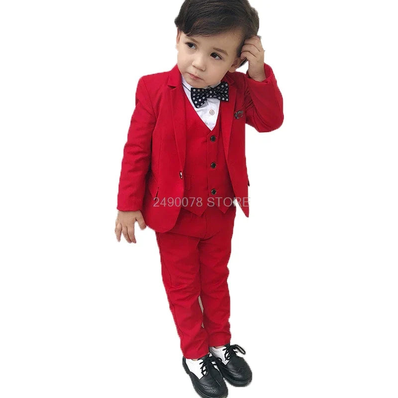 Young boy wearing a SHOWLU FASHION STORE LUOBOBEIBEI 3-piece wedding suit with tuxedo jacket, shirt, and pants for formal occasions.