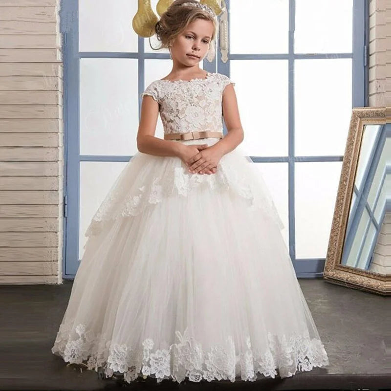 White flower girl dress by Showlu Fashion with lace appliqué and beaded details, perfect for first communion or special occasions.