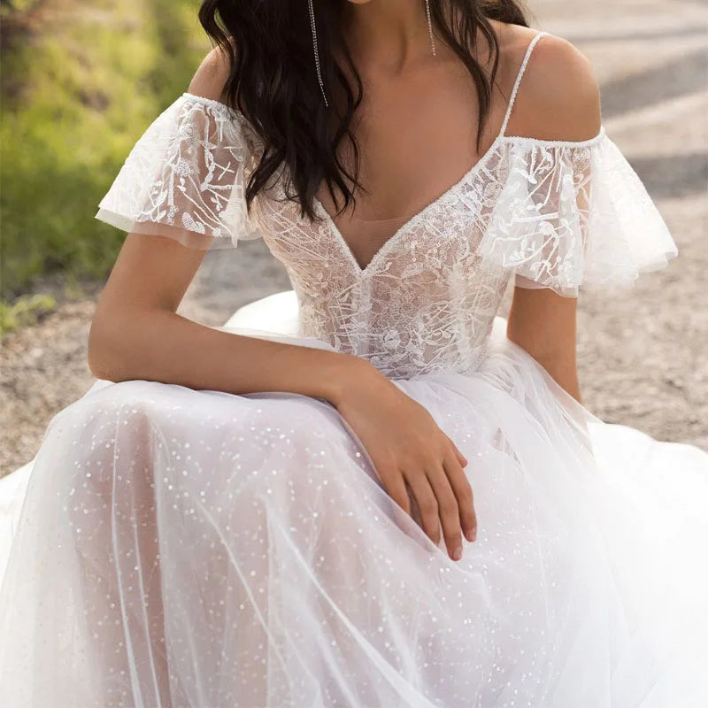 White V-neck lace wedding dress by Showlu Fashion, sleeveless tulle bridal gown with elegant lace details and a fitted silhouette.