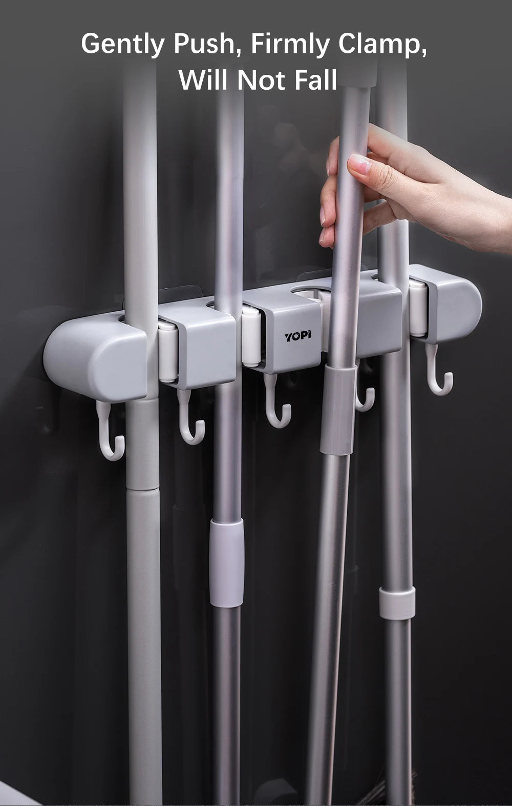 Wall mounted broom holder by Showlu Smart General with hooks for organizing brooms and cleaning tools on the wall.