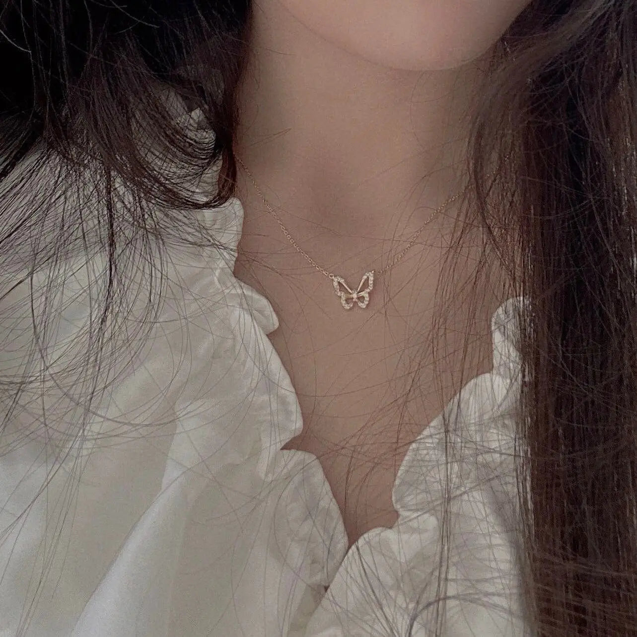 Hollow butterfly pendant necklace with zircon crystals, showcasing a shiny animal choker design for women.