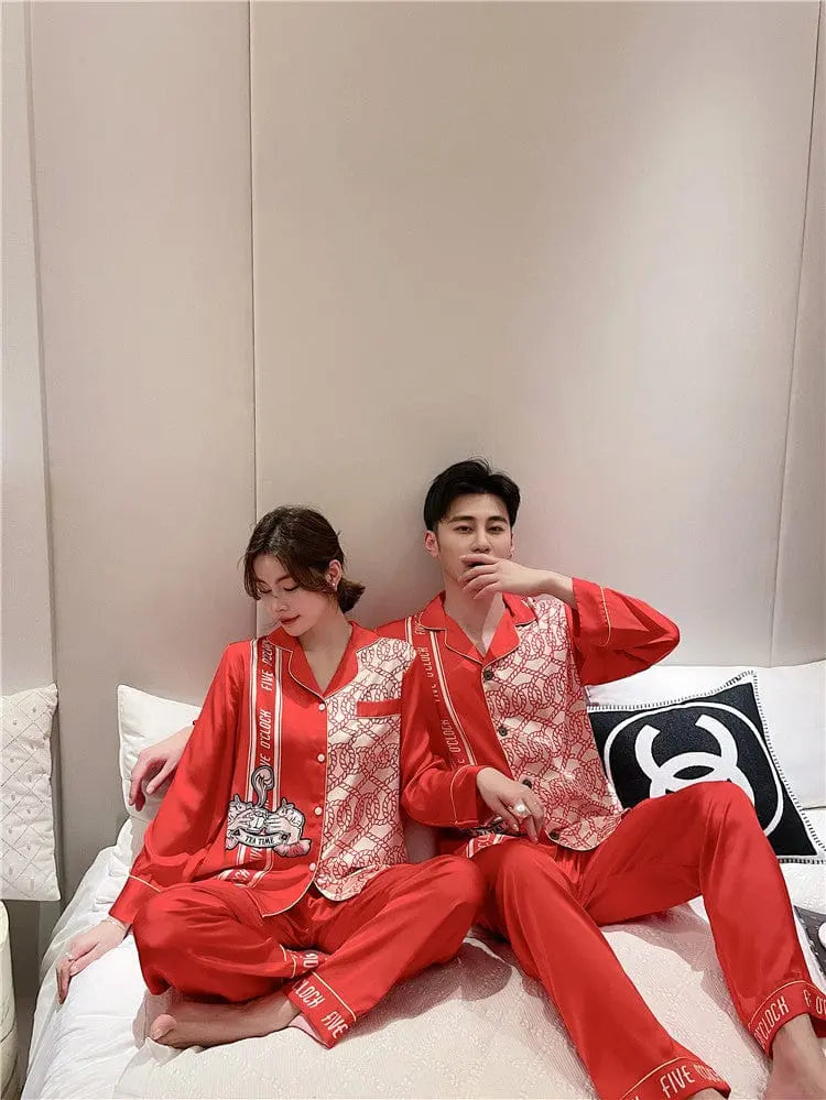 Couple wearing Showlu Fashion silk satin Korean style pajamas set, featuring matching nightwear for men and women.