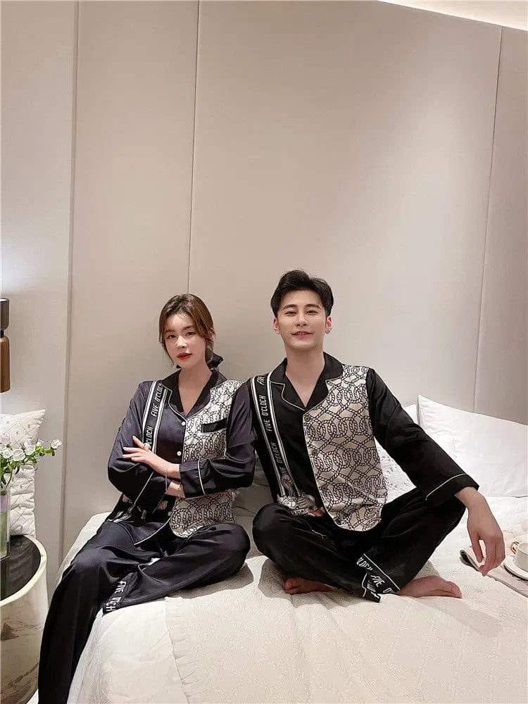 Couple wearing Showlu Fashion Silk Satin Korean-style pajamas set, stylish nightwear with smooth satin fabric and elegant design.