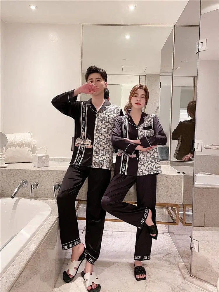 Couple wearing Showlu Fashion silk satin Korean style pajamas set, stylish nightwear for men and women, sexy and comfortable.