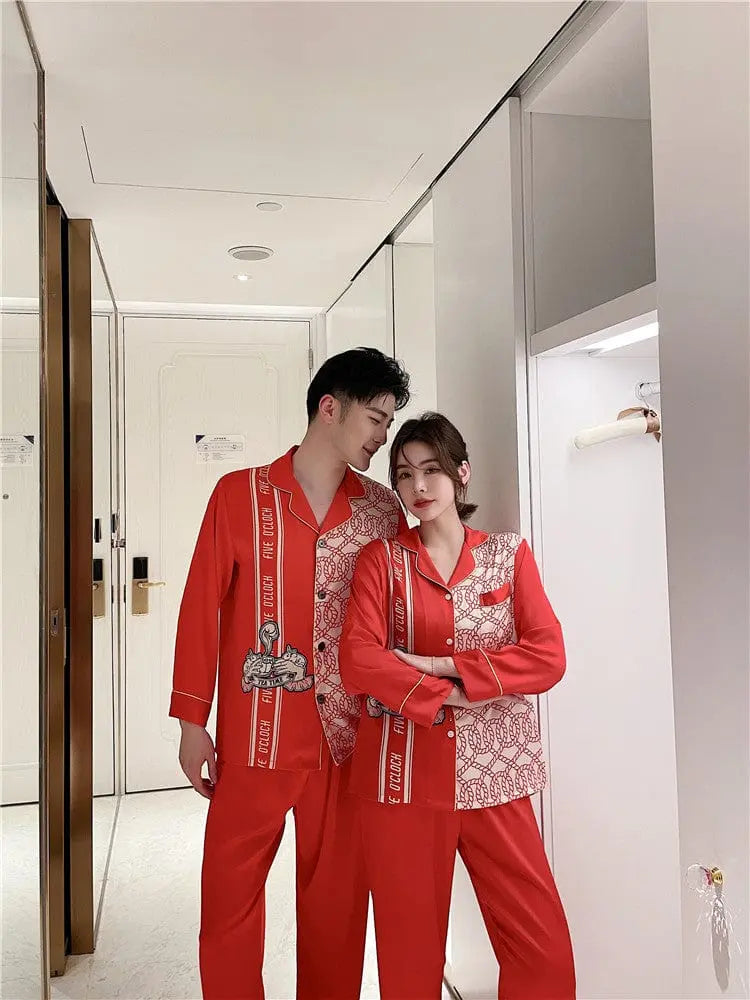 Couple wearing Showlu Fashion silk satin Korean style pajamas set, stylish nightwear with matching tops and bottoms for men and women.