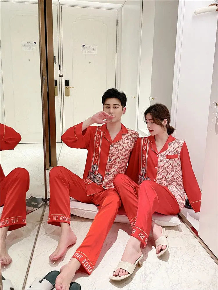 Couple wearing Showlu Fashion silk satin Korean-style pajamas set, stylish nightwear for men and women.
