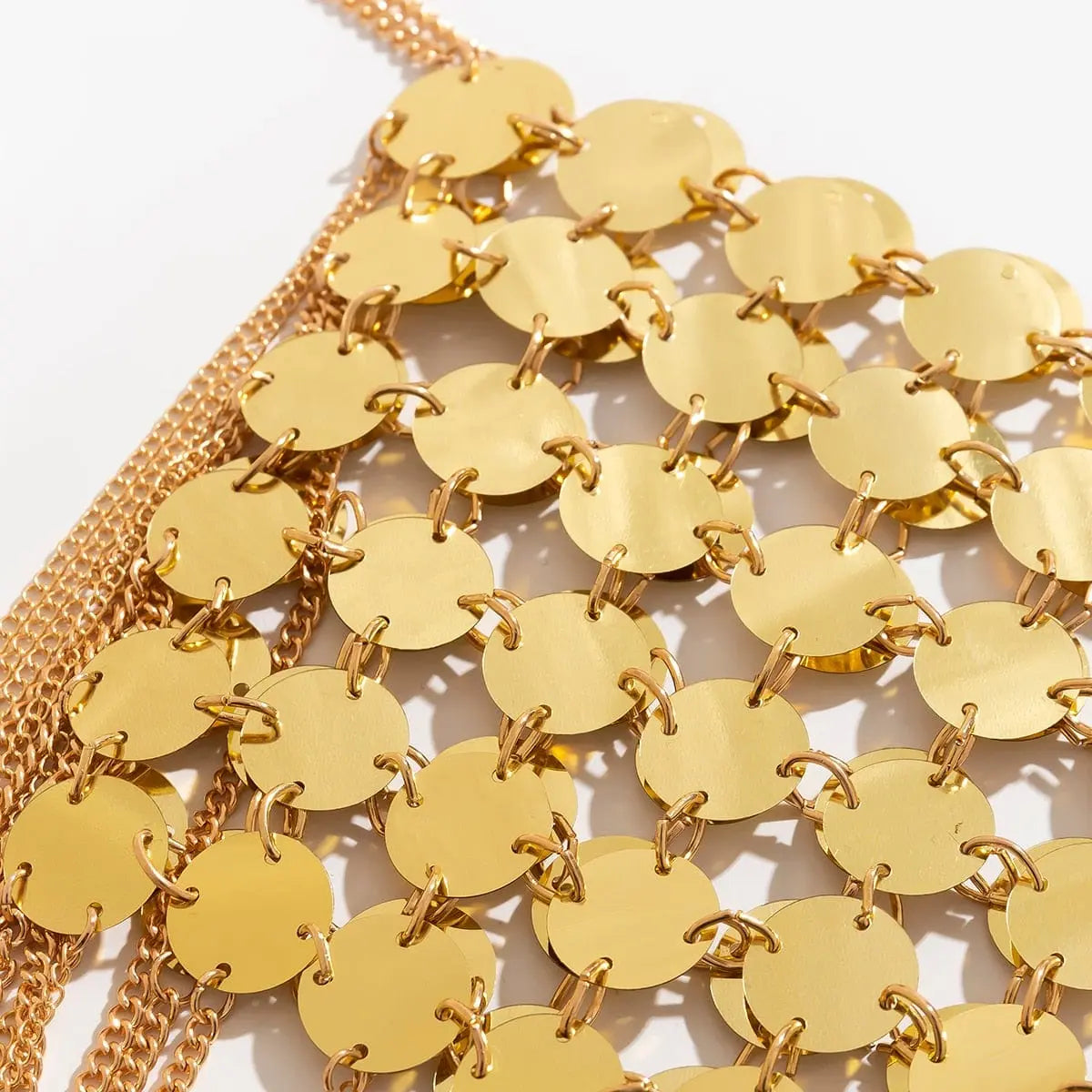 Gold metal chain sequins shoulder body chain for women, featuring tassels and punk-inspired harness design.