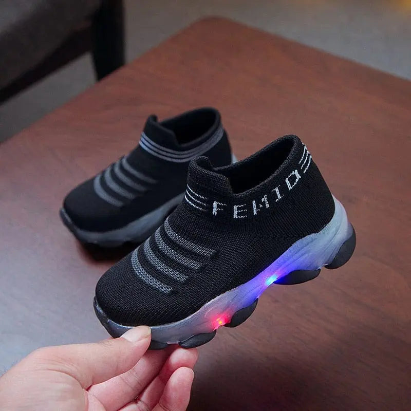Kids LED light-up sneakers by Showlu Fashion featuring mesh slip-on design and luminous soles for children and toddlers.