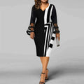 Plus size printed mesh wrap dress with long sleeves and V-neck from Showlu Fashion, showcasing a gauzy, stylish design.