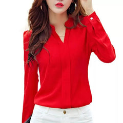 A woman wears a long-sleeved, slim-fit red chiffon blouse with a V-neckline.