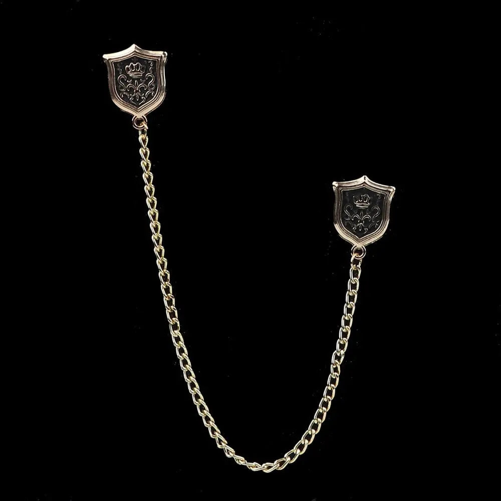 Anel Demosthene Dragon lapel pin with retro tassel chain, worn on a suit collar as a stylish brooch accessory.