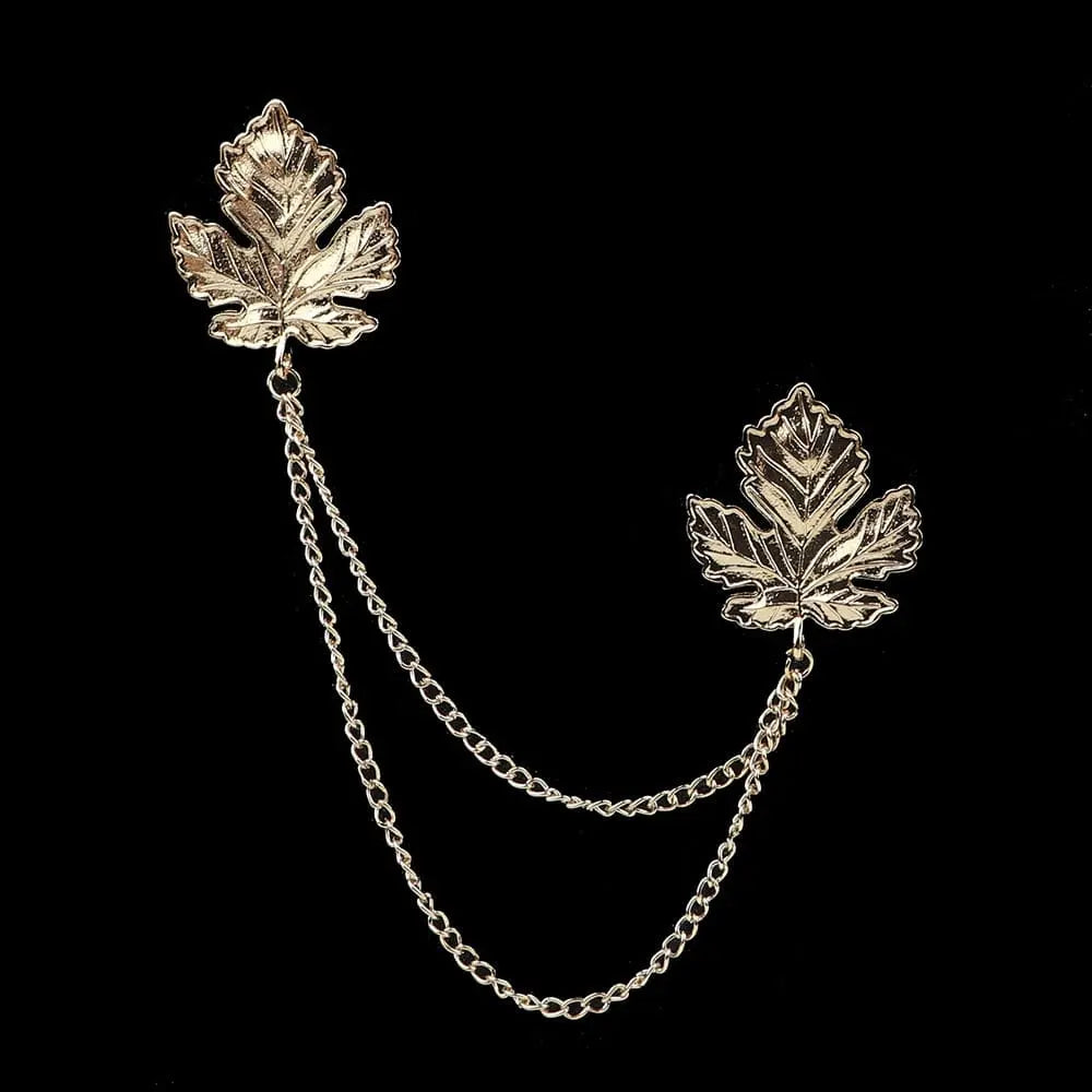 Anel Demosthene Dragon lapel pin with retro tassel chain on a man’s suit lapel, stylish accessory for formal occasions.